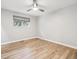 Neutral bedroom with light wood floors, a window, and modern ceiling fan at 1333 W Peakview Ave, Littleton, CO 80120