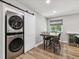 Dining area next to laundry with stacked washer/dryer and a wine refrigerator under countertop at 1333 W Peakview Ave, Littleton, CO 80120
