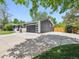 View of the home's exterior showcasing a large driveway, modern garage door, and well-maintained landscaping at 1333 W Peakview Ave, Littleton, CO 80120