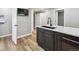 Modern kitchen area featuring sleek countertops, stainless steel dishwasher, and convenient bar sink at 1333 W Peakview Ave, Littleton, CO 80120