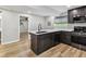 Modern kitchen equipped with stainless steel appliances, ample counter space, and view into an adjacent room at 1333 W Peakview Ave, Littleton, CO 80120