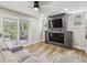 Stylish living room with a decorative fireplace, mounted TV, and access to a patio with outdoor seating at 1333 W Peakview Ave, Littleton, CO 80120