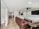 Open-concept living room featuring modern decor, hardwood floors, and seamless flow to the kitchen and dining areas at 1333 W Peakview Ave, Littleton, CO 80120