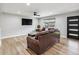 Cozy living room showcases wood floors, a new ceiling fan, updated light fixtures, and ample natural light at 1333 W Peakview Ave, Littleton, CO 80120