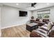 Inviting living room features a modern ceiling fan, new floors and large window with light-filtering shades at 1333 W Peakview Ave, Littleton, CO 80120