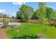 Spacious backyard with a concrete patio and a well-maintained lawn, perfect for outdoor entertaining at 9698 Queenscliffe Dr, Highlands Ranch, CO 80130