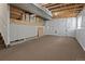 Unfinished basement with carpeted area and exposed ceiling, providing ample space for customization and storage at 9698 Queenscliffe Dr, Highlands Ranch, CO 80130