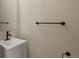 This is a modern half-bath with a vessel sink, dark fixtures, and a simple towel bar at 9698 Queenscliffe Dr, Highlands Ranch, CO 80130