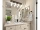 Bright bathroom with modern lighting, a large mirror, and stylish vanity at 9698 Queenscliffe Dr, Highlands Ranch, CO 80130