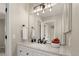This is a light and airy bathroom, with granite countertops, new fixtures, and contemporary lighting at 9698 Queenscliffe Dr, Highlands Ranch, CO 80130