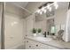 Well-lit bathroom featuring a tub/shower combo, sleek vanity, and modern fixtures at 9698 Queenscliffe Dr, Highlands Ranch, CO 80130