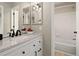 Bright bathroom features modern vanity with a granite countertop and a bathtub shower combination at 9698 Queenscliffe Dr, Highlands Ranch, CO 80130