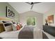 Bedroom featuring large windows, ceiling fan, stylish decor, and a modern headboard at 9698 Queenscliffe Dr, Highlands Ranch, CO 80130