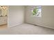 This is a clean and bright bedroom with neutral tones, a large window, and soft carpeting at 9698 Queenscliffe Dr, Highlands Ranch, CO 80130