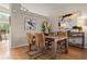 Elegant dining area with hardwood floors, modern art, and ample natural light for Gathering meals at 9698 Queenscliffe Dr, Highlands Ranch, CO 80130