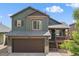 Inviting two-story home featuring a covered porch and a two-car garage, perfect for families at 9698 Queenscliffe Dr, Highlands Ranch, CO 80130