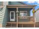 Charming front porch with hanging plants and a cozy entryway, ideal for relaxing at 9698 Queenscliffe Dr, Highlands Ranch, CO 80130