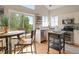 Bright, functional kitchen with an eat-in breakfast nook, stainless appliances, and ample sunlight at 9698 Queenscliffe Dr, Highlands Ranch, CO 80130