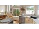 Modern kitchen with stainless appliances, white cabinetry, and a breakfast bar for convenient dining at 9698 Queenscliffe Dr, Highlands Ranch, CO 80130