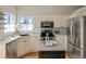 Updated kitchen with stainless appliances, granite countertops, and ample cabinet space, ideal for cooking at 9698 Queenscliffe Dr, Highlands Ranch, CO 80130