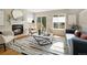 Cozy living room featuring a fireplace, stylish chairs, and a decorative rug at 9698 Queenscliffe Dr, Highlands Ranch, CO 80130