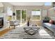 Bright living room with fireplace, sliding door access to the yard, and stylish decor at 9698 Queenscliffe Dr, Highlands Ranch, CO 80130