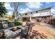 Inviting backyard space featuring a fire pit, patio seating, and lush greenery, ideal for gatherings at 7082 W Morraine Dr, Littleton, CO 80128