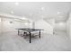 Spacious basement with ample lighting and carpet, featuring a game area for entertainment at 7082 W Morraine Dr, Littleton, CO 80128