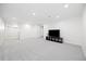 Spacious basement with neutral carpeting and a modern entertainment center, perfect for relaxation at 7082 W Morraine Dr, Littleton, CO 80128