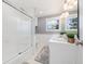 Well-lit bathroom with a shower-tub combo, double vanity, and fresh, clean finishes at 7082 W Morraine Dr, Littleton, CO 80128