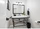 Charming bathroom featuring unique vessel sink, black fixtures, and decorative mirror at 7082 W Morraine Dr, Littleton, CO 80128