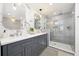 Elegant bathroom with dual sinks, marble accents, and a glass-enclosed shower for a luxurious feel at 7082 W Morraine Dr, Littleton, CO 80128
