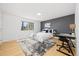 Bright bedroom with hardwood floors, a cozy rug, and a modern desk area perfect for work or study at 7082 W Morraine Dr, Littleton, CO 80128