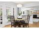 Cozy dining area with modern light fixture and view into living room at 7082 W Morraine Dr, Littleton, CO 80128