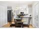 Bright dining room adjacent to kitchen with table and seating for four at 7082 W Morraine Dr, Littleton, CO 80128