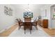 Elegant dining room with a large table, chandelier, and natural light at 7082 W Morraine Dr, Littleton, CO 80128