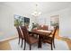 Bright dining room with classic wood furnishings, a window, and stylish accents at 7082 W Morraine Dr, Littleton, CO 80128