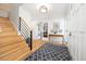Bright foyer with hardwood floors, elegant staircase, and stylish decor at 7082 W Morraine Dr, Littleton, CO 80128