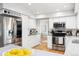 Bright kitchen with stainless steel appliances, white cabinets, and granite countertops at 7082 W Morraine Dr, Littleton, CO 80128