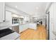 Modern kitchen with white cabinetry, stainless steel appliances, and hardwood floors at 7082 W Morraine Dr, Littleton, CO 80128