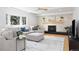 Comfortable living room featuring a fireplace, ceiling fan, and large windows at 7082 W Morraine Dr, Littleton, CO 80128