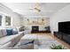 Inviting living room with modern fireplace, ceiling fan, and natural light at 7082 W Morraine Dr, Littleton, CO 80128