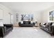 Bright living room featuring hardwood floors, ample seating, and modern accents at 7082 W Morraine Dr, Littleton, CO 80128