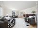 Spacious living room with hardwood floors, large windows, and neutral decor at 7082 W Morraine Dr, Littleton, CO 80128