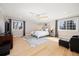 Spacious main bedroom with ample natural light, ceiling fan, and hardwood floors at 7082 W Morraine Dr, Littleton, CO 80128