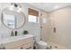 Stylish bathroom with a round mirror and walk-in shower at 953 Stuart St, Denver, CO 80204