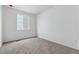 Cozy bedroom with plush carpeting, a bright window, and freshly painted white walls at 19110 E 96Th Pl, Commerce City, CO 80022