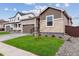 Charming single-Gathering home showcasing stone accents, a two-car garage, and a well-manicured lawn at 19110 E 96Th Pl, Commerce City, CO 80022