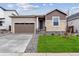 Charming single-Gathering home showcasing stone accents, a two-car garage, and a well-manicured lawn at 19110 E 96Th Pl, Commerce City, CO 80022