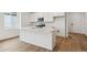 Well-equipped kitchen featuring white cabinets, stainless steel appliances, and a functional center island at 19110 E 96Th Pl, Commerce City, CO 80022